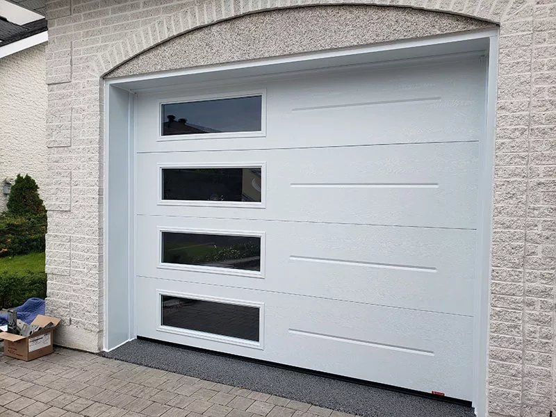 A white garage door with windows, offering an elegant and functional design.